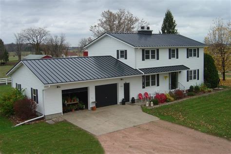 grey metal roof houses|grey house with black awnings.